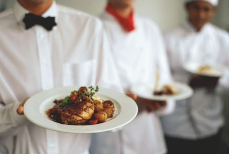 AA Catering Services staff serving plated meals