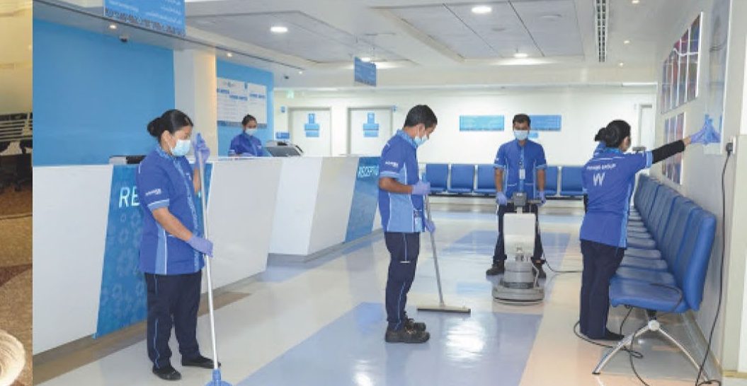 AAGOC housekeeping team cleaning a hospital reception area